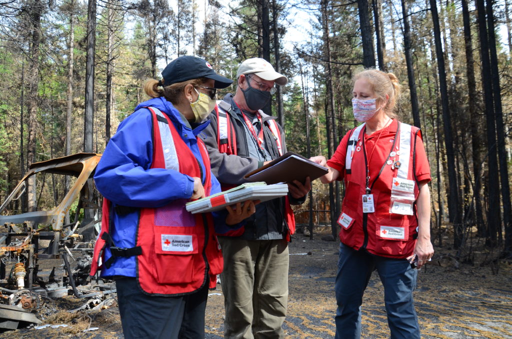Red Cross volunteers Rita Gregorits, Hillary Waneke, and Phil Doolittle conducting disaster assessments in Blue River, Oregon. Photo by Lynette Nyman / Red Cross Cascades.
