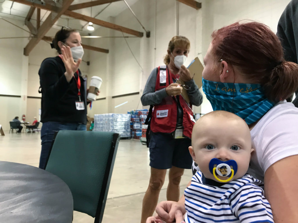 Shiloh with his mom, Mary, talking with Red Cross volunteers at the Red Cross shelter at the Oregon State Fairgrounds in Salem, Oregon on Sept. 17, 2020. Photo by Lynette Nyman/American Red Cross.