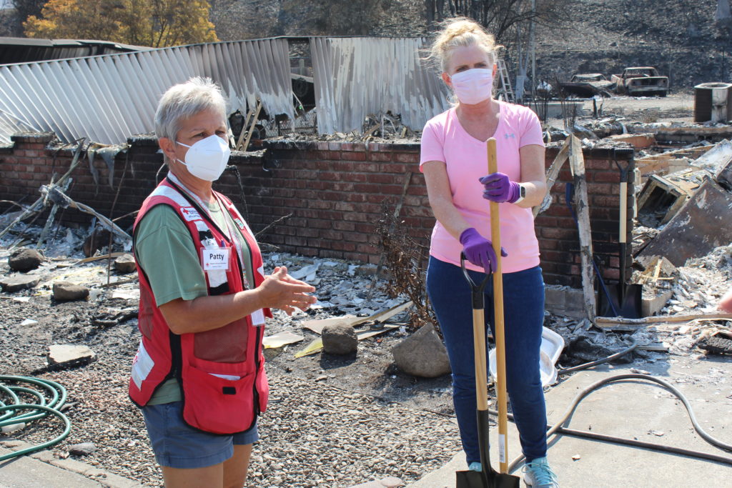 Patty Albin working with a home owner to provide a little comfort and hope during such a difficult time in Talent, Oregon on Sept. 23, 2020. Photo by Axl David/American Red Cross.
