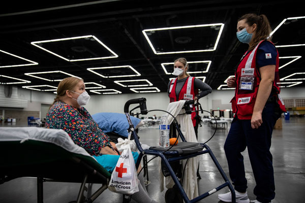 Kathy Gee speaks to American Red Cross nurses at an American Red Cross shelter in Portland, OR after fleeing her home because of wildfires in the region on Monday, September 14, 2020.