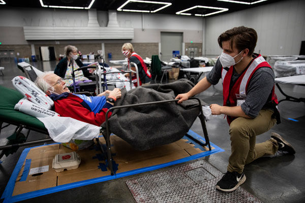 Willem Van Rees and Emily Girard of the American Red Cross talk with Paul and Sue Barnes, at an American Red Cross shelter in Portland, OR on Monday, September 14, 2020. The shelter was set up for people evacuating as wildfires burned throughout the region.