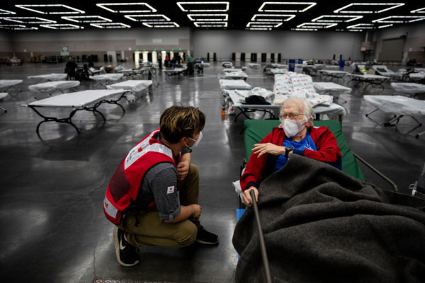 Willem Van Rees of the American Red Cross talks to Paul Douglas Barnes, at an American Red Cross shelter for wildfire evacuees in Portland, OR