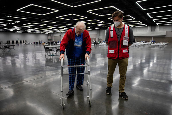 Willem Van Rees of the American Red Cross walks with Paul Douglas Barnes, at an American Red Cross shelter for wildfire evacuees in Portland, OR