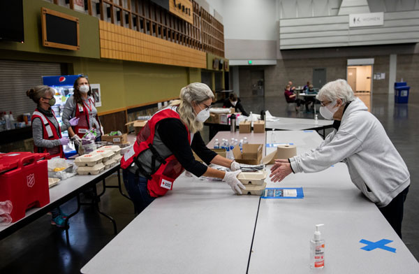 Janet Kessler gets a meal from the American Red Cross at a shelter for wildfire evacuees in Portland, OR