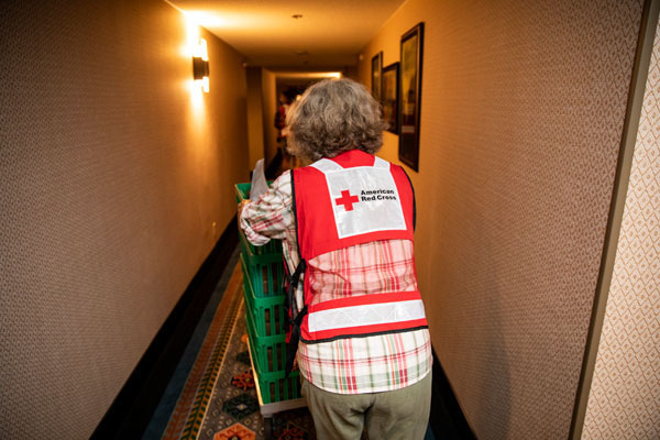 American Red Cross volunteer Eliza Roaring Springs delivers meals to evacuees from the Oregon wildfires at a hotel that is being used by the American Red Cross as a shelter in, Eugene, OR