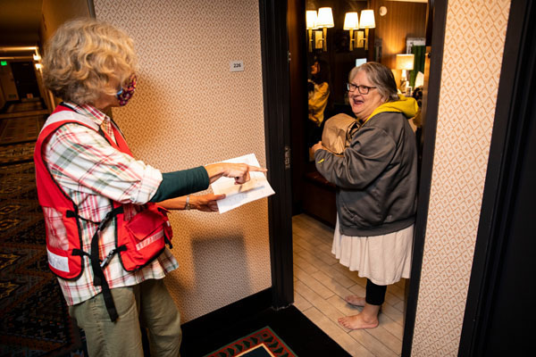 Ruby Gott receives a meal from American Red Cross volunteer Eliza Roaring Springs, at a hotel that is being used by the American Red Cross as a shelter for evacuees from the Oregon wildfires in, Eugene, OR