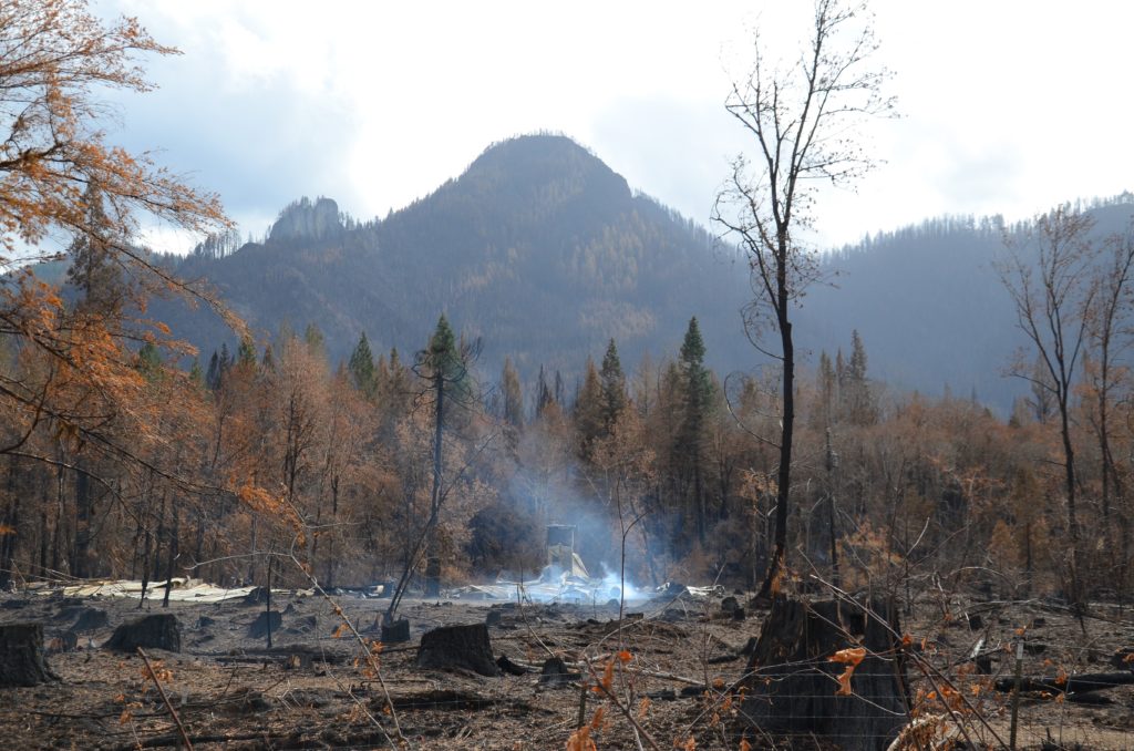 A scene of still smoldering rubble in Blue River, Oregon following devastating wildfires in September 2020. Photo by Lynette Nyman / American Red Cross.